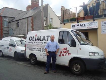 climate cardiff plumber in front of fleet vans parked by climate house