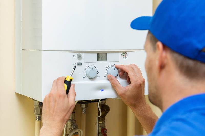 man adjusting central heating