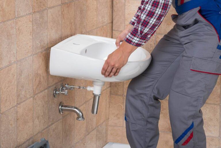 Handyman Installing Sink In Bathroom