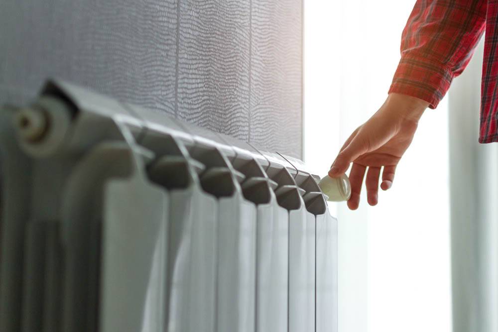 Person With Hand On Radiator